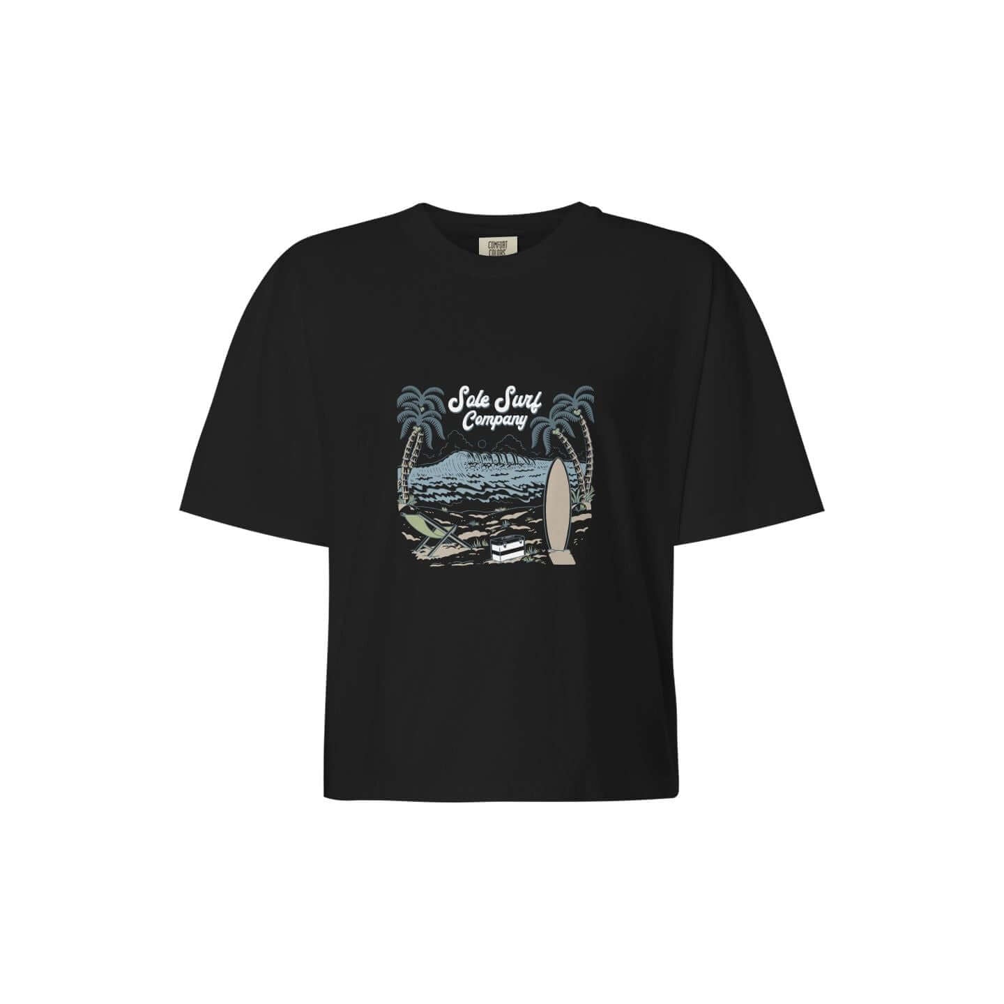 Women's Boxy Island Tee featuring a surf-themed graphic and palm trees on a black background.