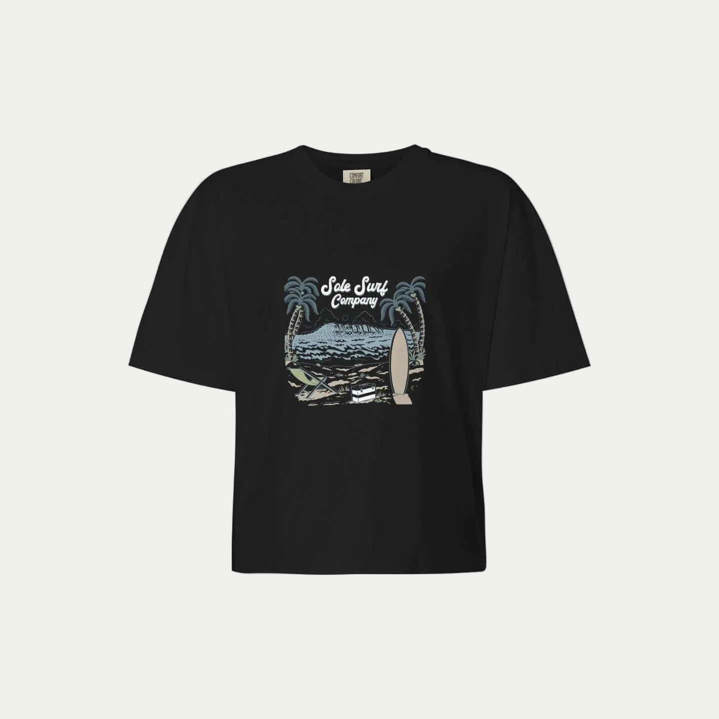 Womens boxy island tee featuring a black cropped design with palm trees and surfboard graphic.