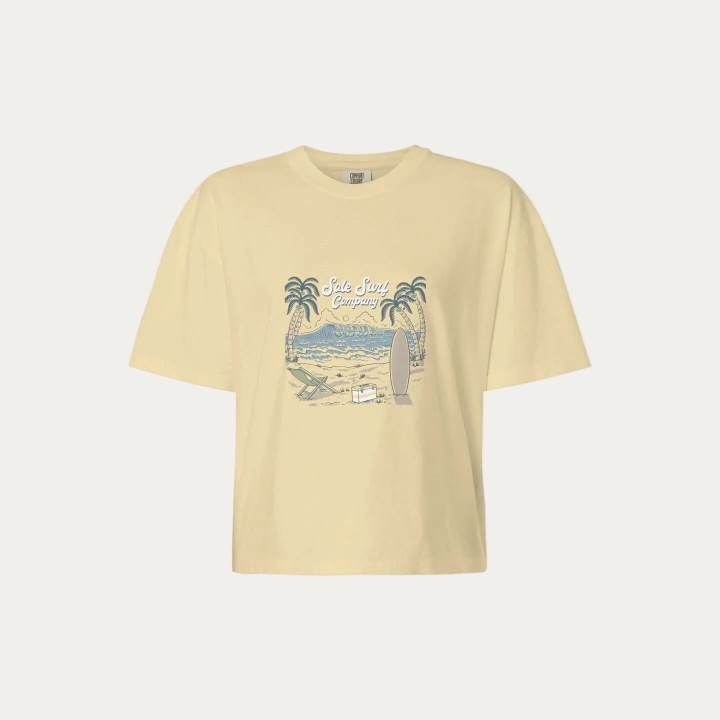 womens boxy island tee featuring a tropical graphic with palm trees and a surfboard on a relaxed fit background