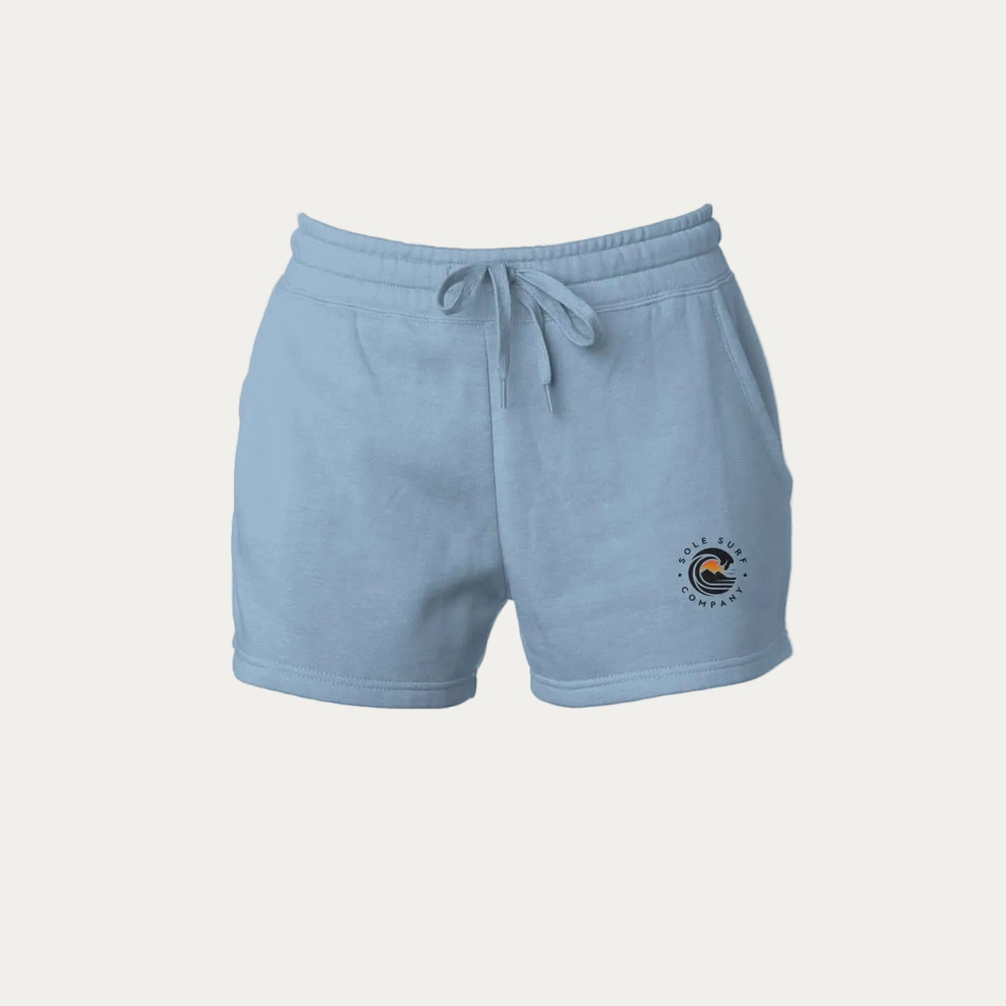 women's tide wash shorts in light blue with wave design logo, perfect for surfing and casual living.