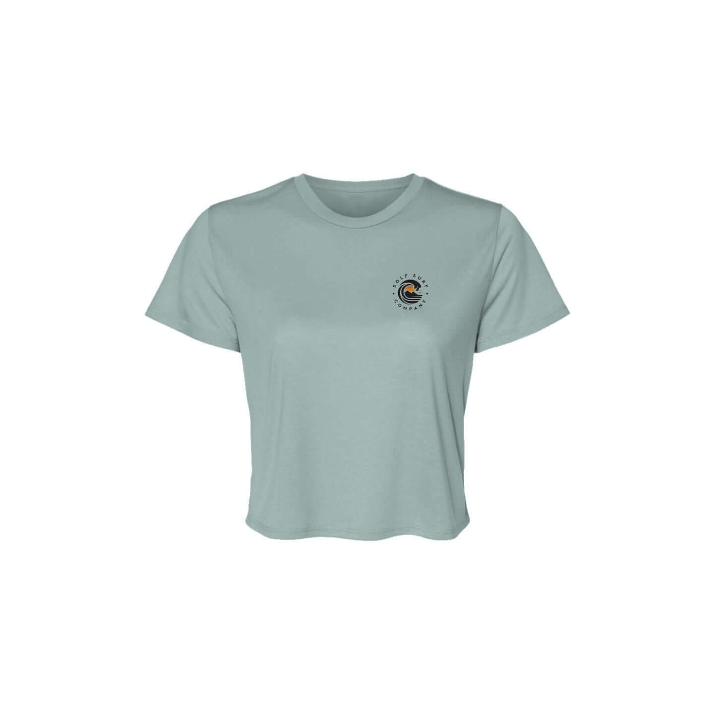 SSC Women’s Flowy Crop Tee – Island Woman in light blue with logo over heart.