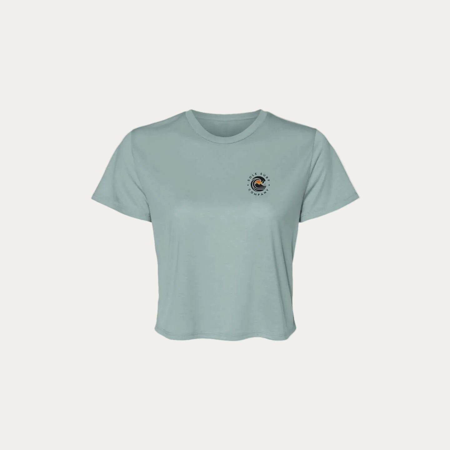 SSC Women’s Flowy Crop Tee – Island Woman in light blue with logo over heart.