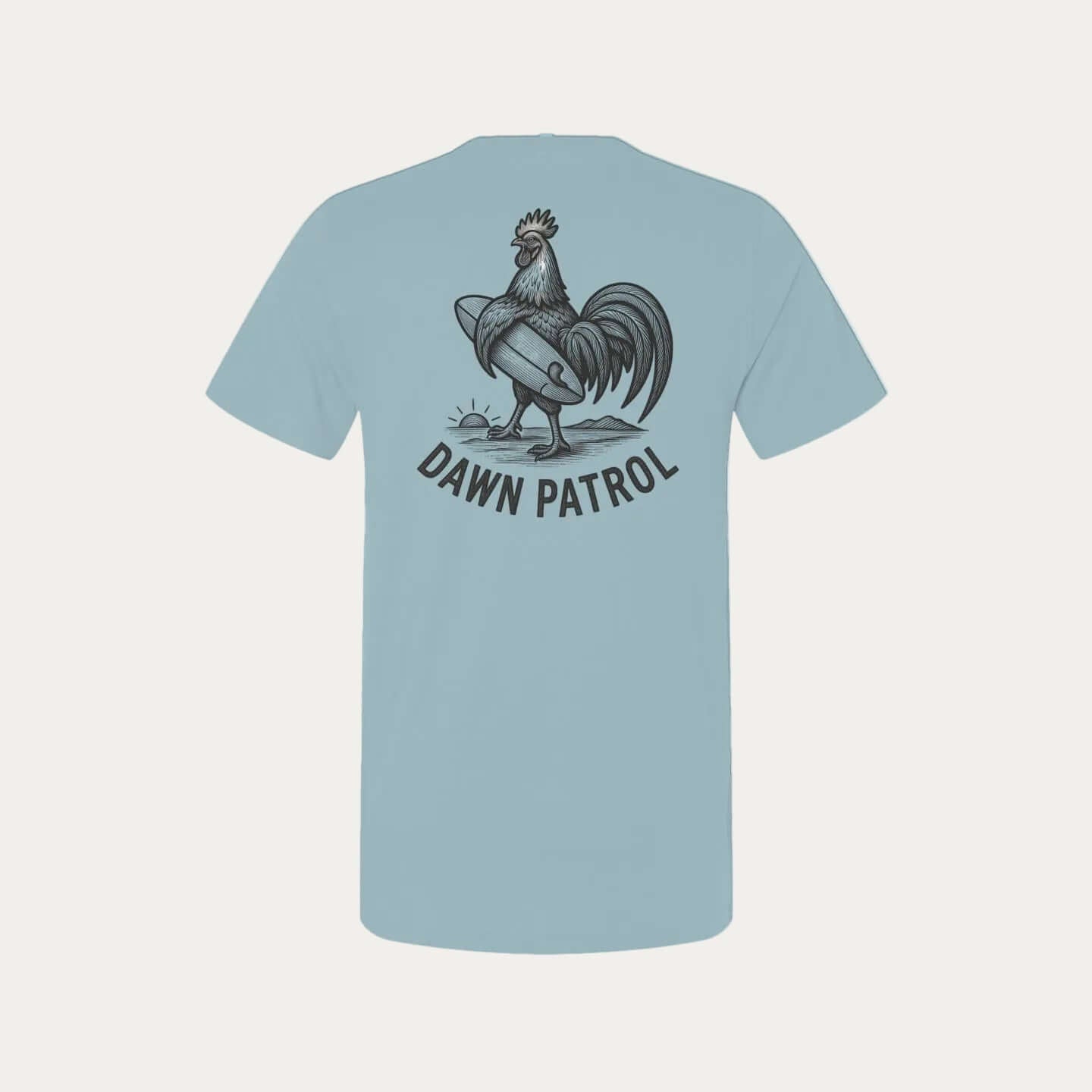 Back view of a light blue t-shirt featuring a hand-drawn rooster and text "DAWN PATROL".