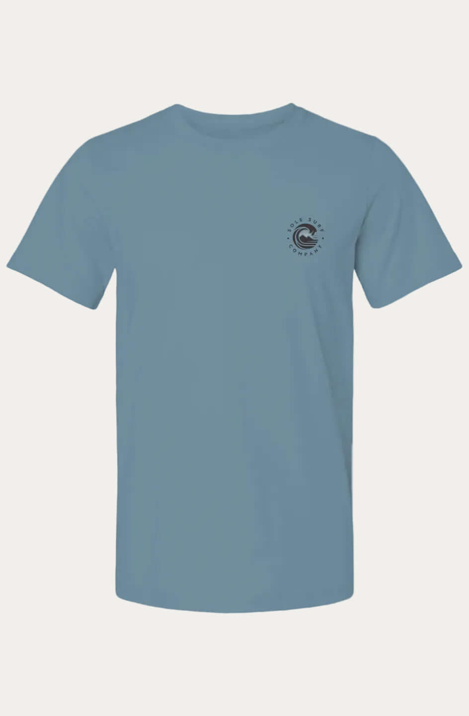 A dusty blue crewneck t-shirt with a small circular black and white logo on the left chest, displayed on a solid white background.