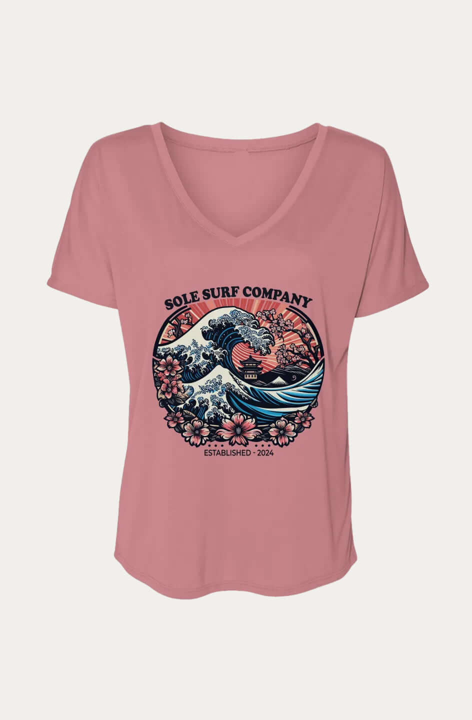 A dusty pink short-sleeve V-neck t-shirt with a circular graphic on the chest featuring a surfer riding a wave, inspired by 'The Great Wave off Kanagawa', with the text 'SOLE SURF COMPANY' and 'EST. 2024'.