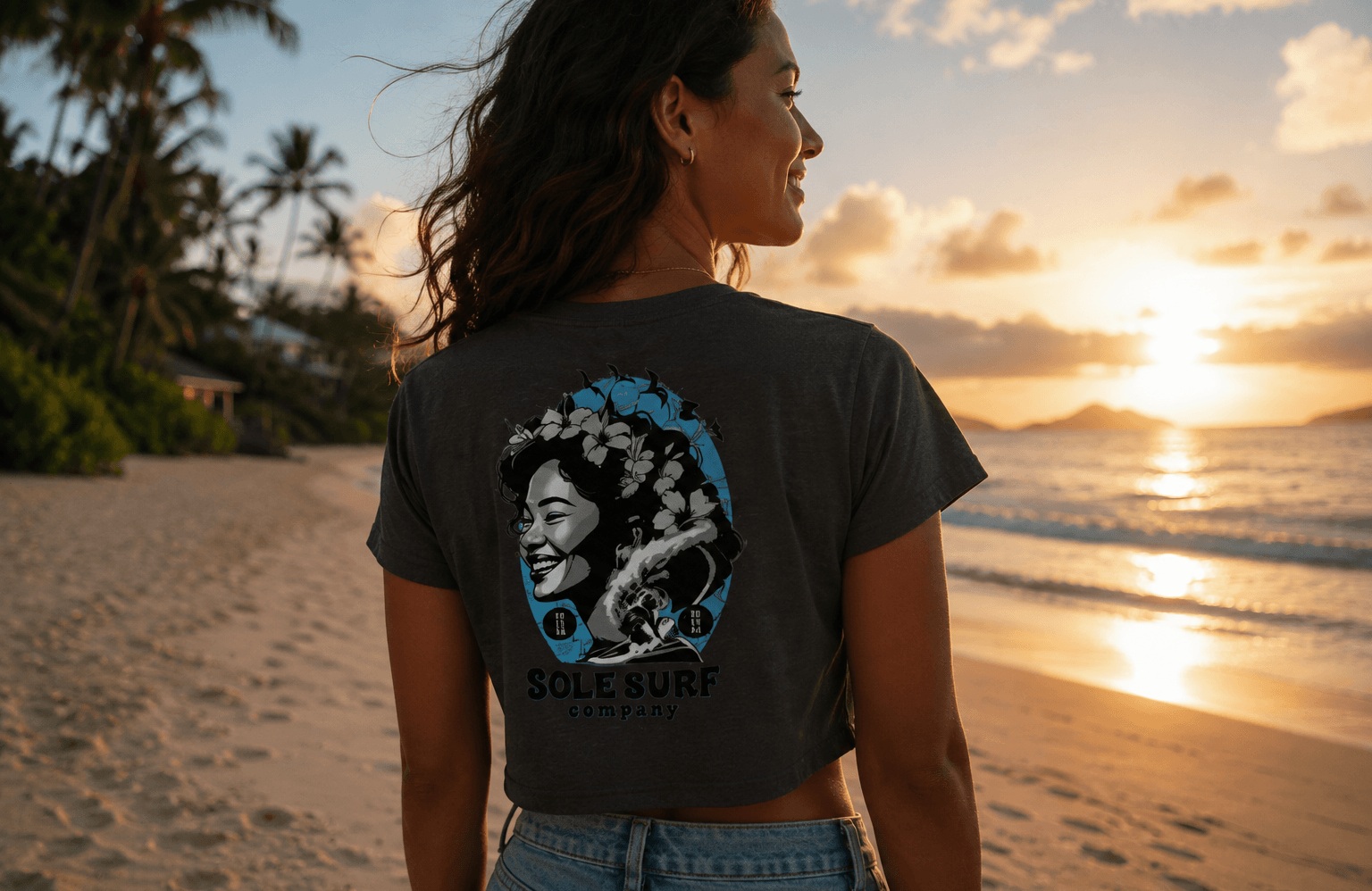 Woman wearing a t-shirt with a graphic design on a beach at sunset