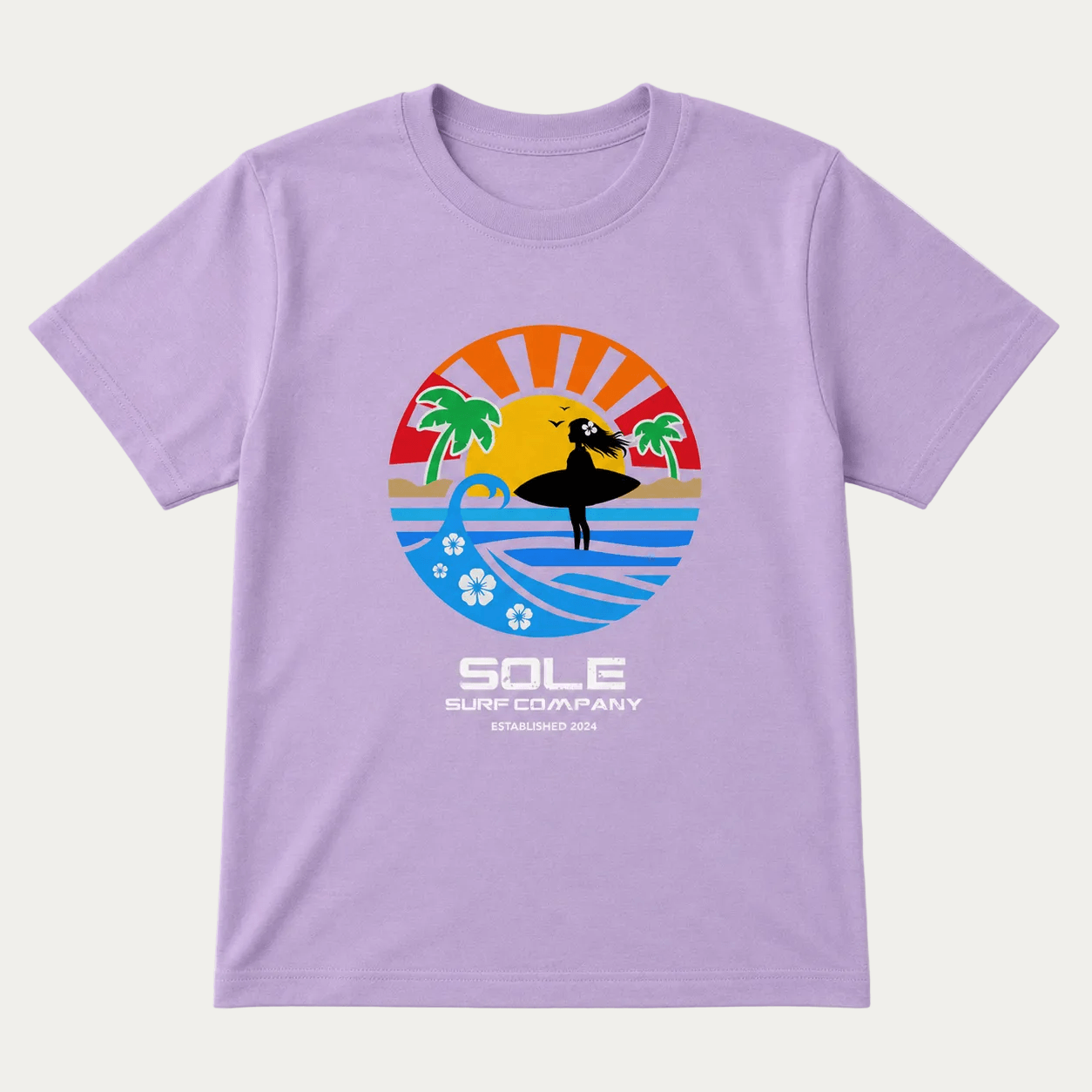 A light purple short-sleeve t-shirt with a colorful graphic of a surfer silhouette against a sunset and ocean, with the text 'SOLE SURF COMPANY' printed below it.