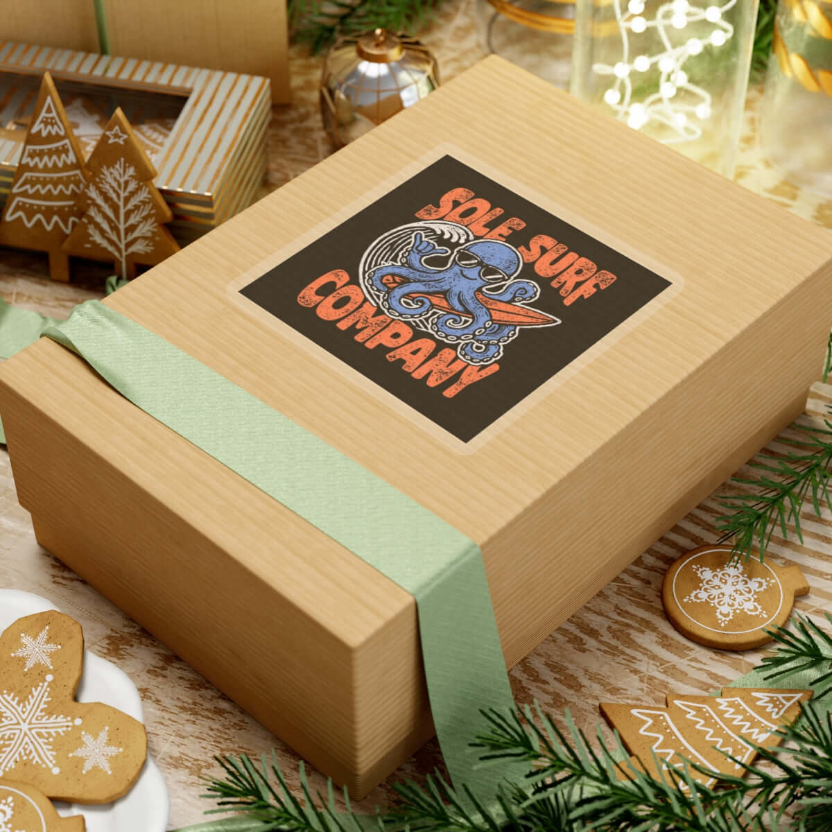 Wooden gift box featuring a colorful Sole Surf Company sticker on top, surrounded by festive decorations.