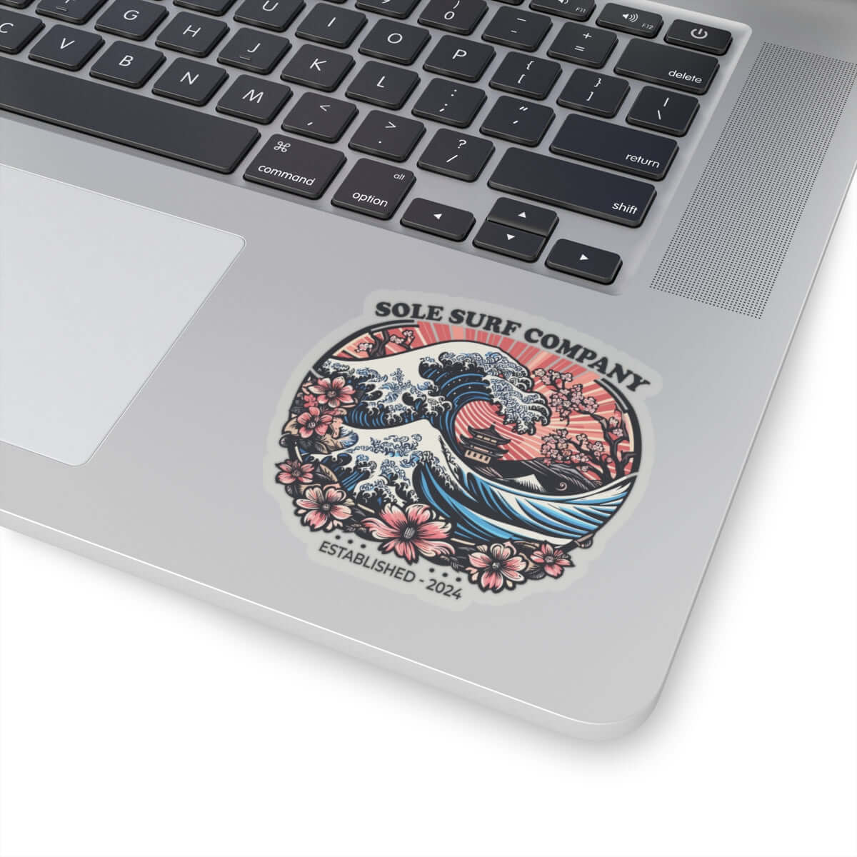 Vibrant Japanese picture sticker on laptop, featuring surf waves and floral design, perfect for adding artistic flair.