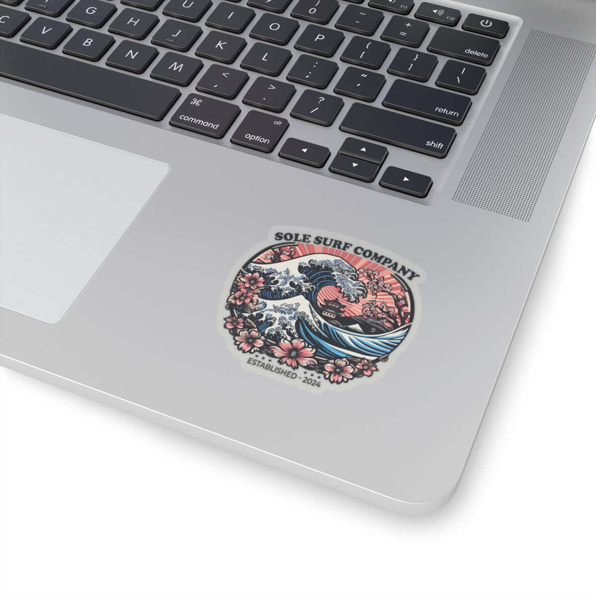 Vibrant Japanese sticker on a laptop, featuring waves and flowers, perfect for surf enthusiasts and artistic touches.