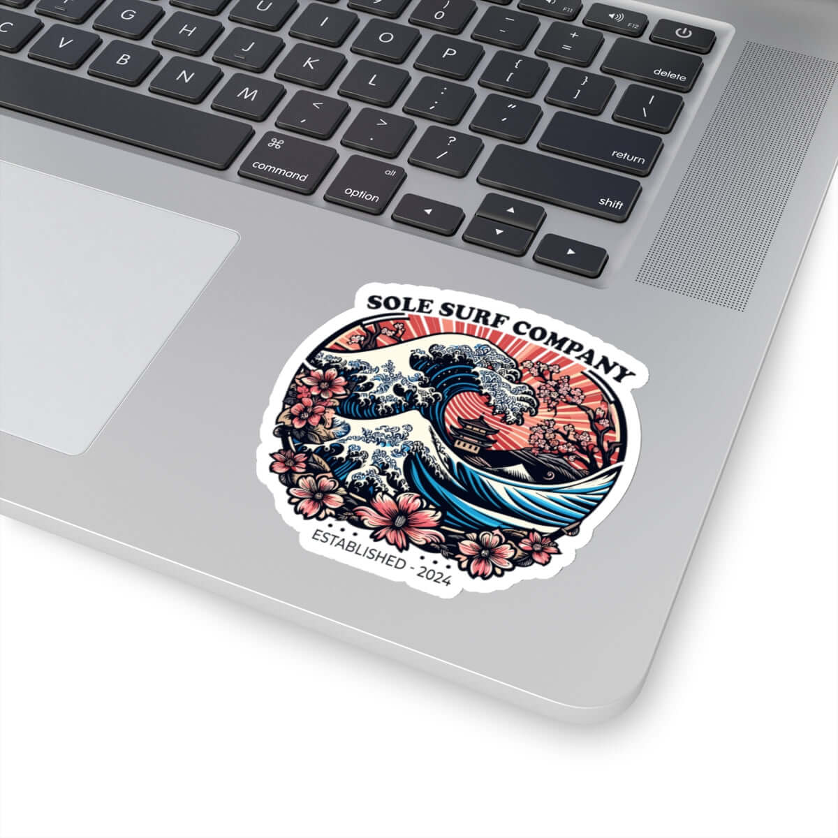 Vibrant Japanese picture sticker on a laptop featuring waves and flowers, perfect for surf lovers and personalizing journals.