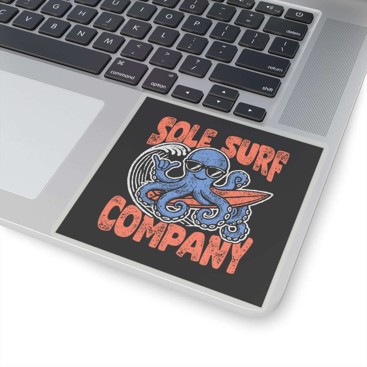 Sole Surf Company sticker featuring a surfing octopus design on a laptop.