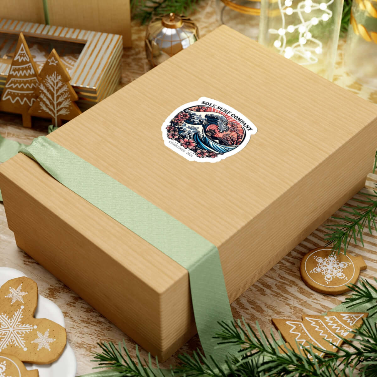Japanese picture sticker on a gift box with decorative ribbon and holiday ornaments.