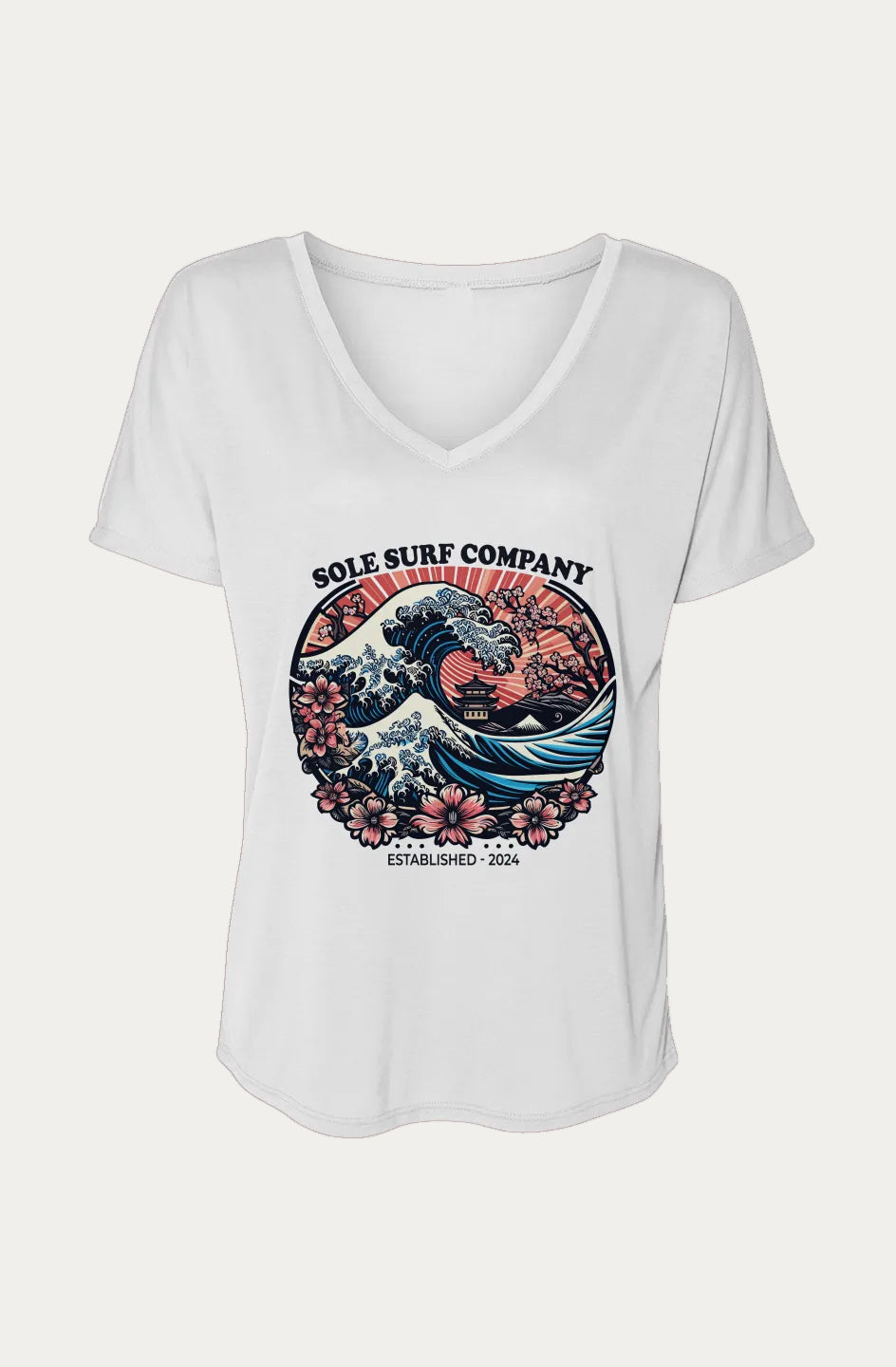 A white women's V-neck t-shirt with a colorful graphic print on the front. The graphic features the text 'SOLE SURF COMPANY' above a stylized wave illustration with pink flowers and a red sun, and 'ESTABLISHED 2024' below it.