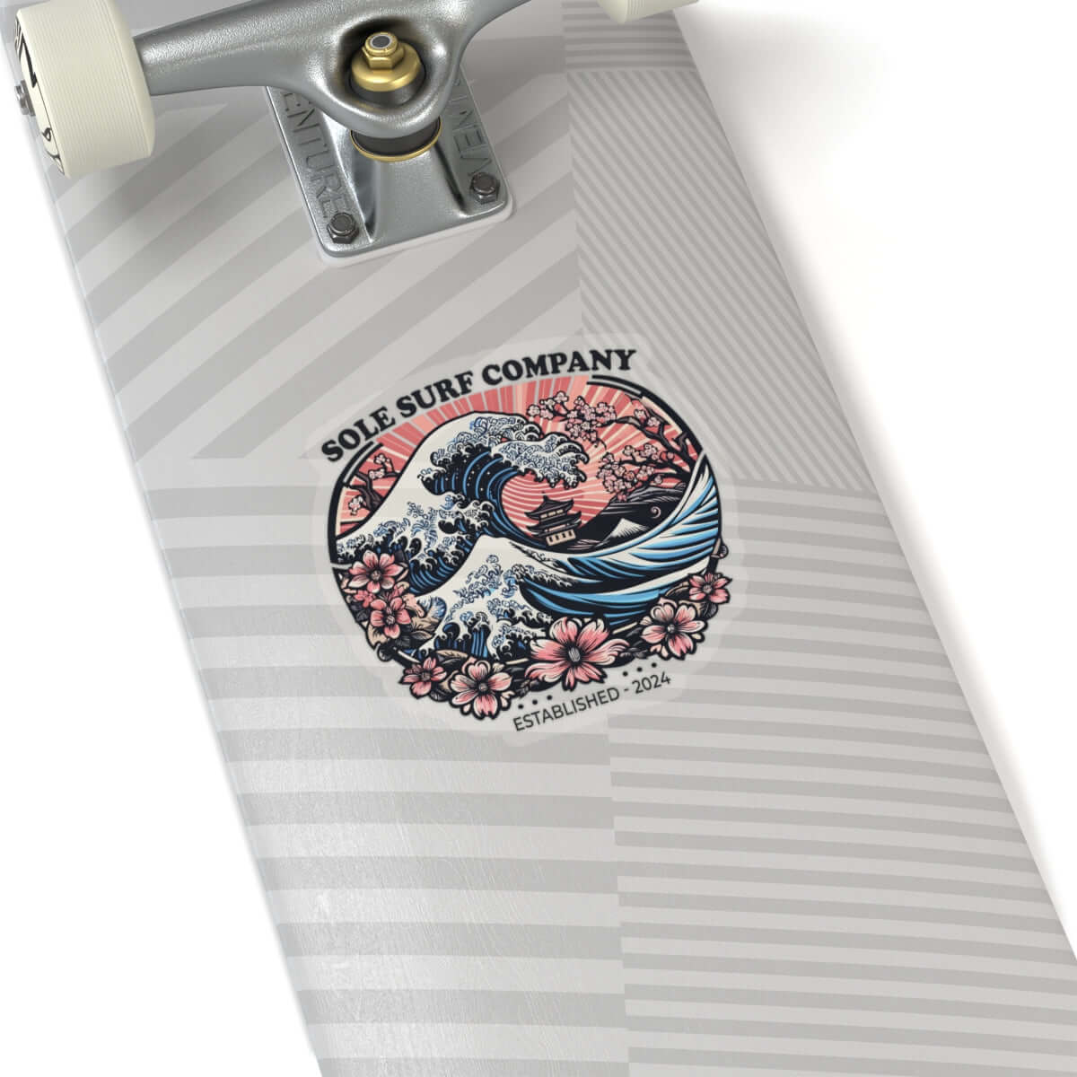 Japanese wave sticker design on a skateboard by Sole Surf Company, featuring vibrant colors and floral elements.