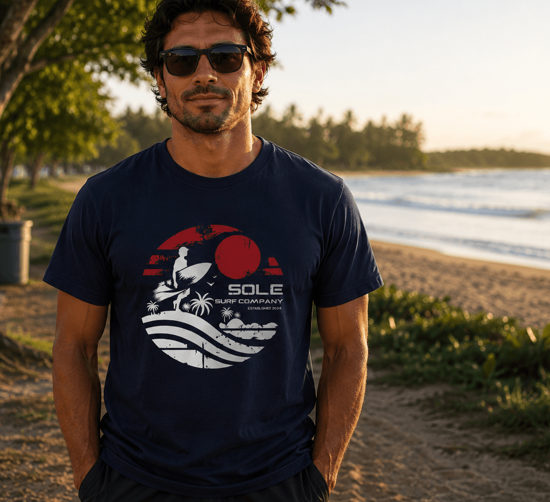 Man wearing a navy blue t-shirt with a logo on a beach