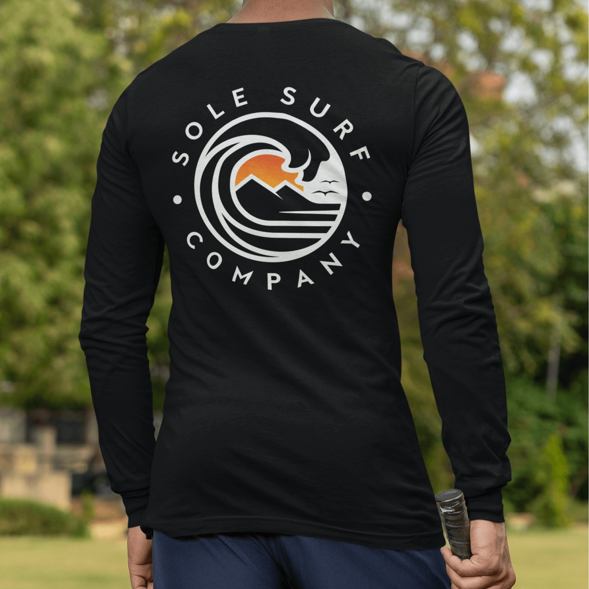 SSC White Logo Long Sleeve surf tee displayed from the back, showcasing the design with ocean waves and a laid-back vibe.